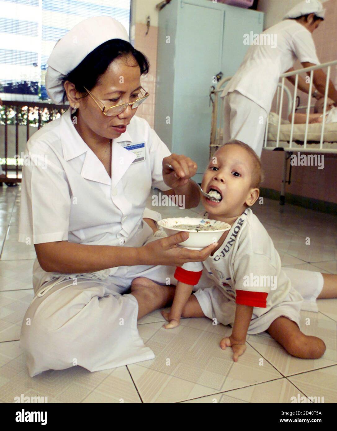 A Nurse Feeds A Child With Birth Defects That Resulted From The Parents Exposure To The Toxic Defoliant Agent Orange At The Tu Du Women S Hospital In Ho Chi Minh City November