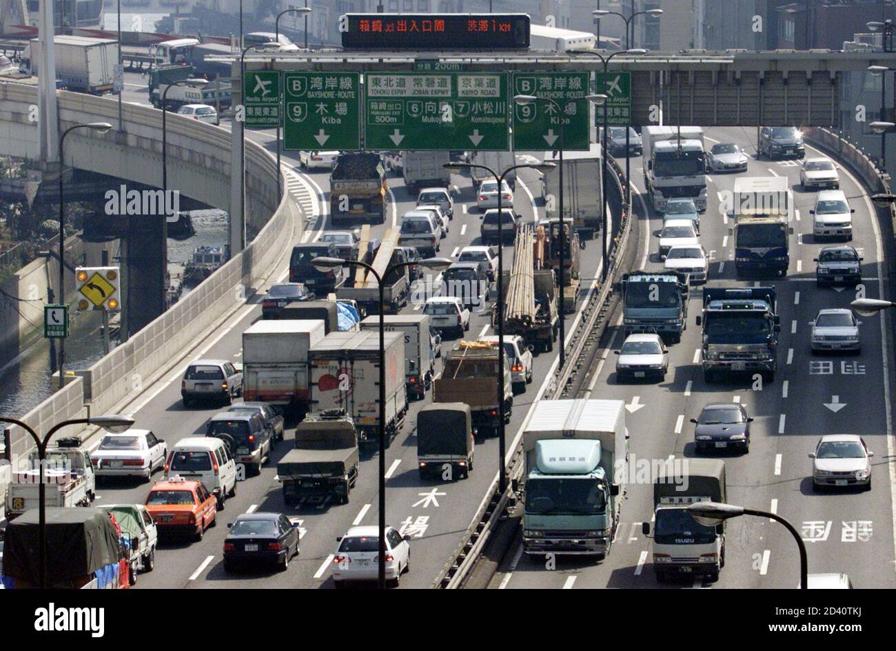 Vehicles are trapped in traffic on a Tokyo expressway on March 14, 2001.  Japan's Transport Ministry plans to offer subsidies to bus and truck  operators in the three main metropolitan regions to