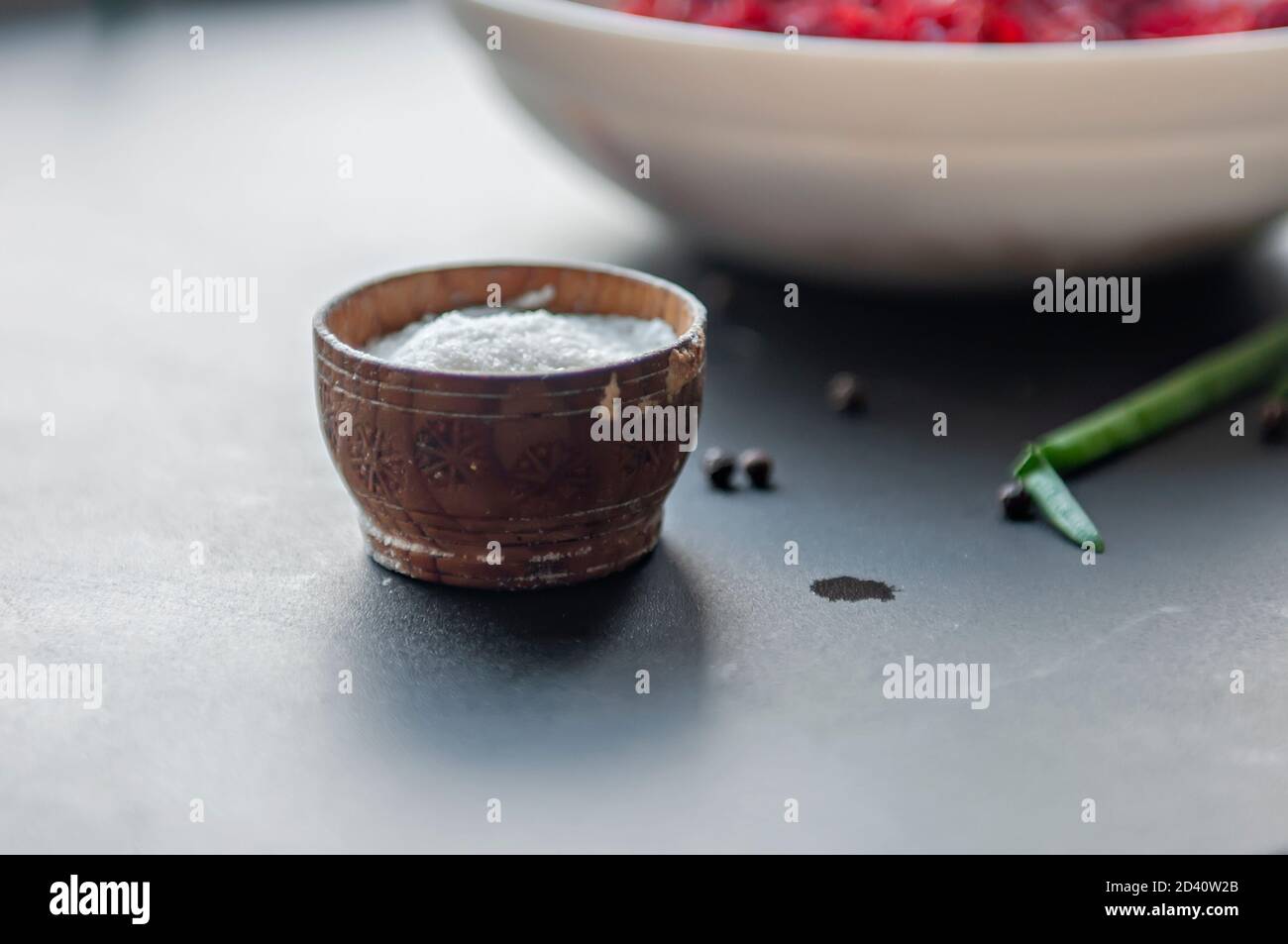 Cooking spices sea salt in a wooden container black pea pepper on the