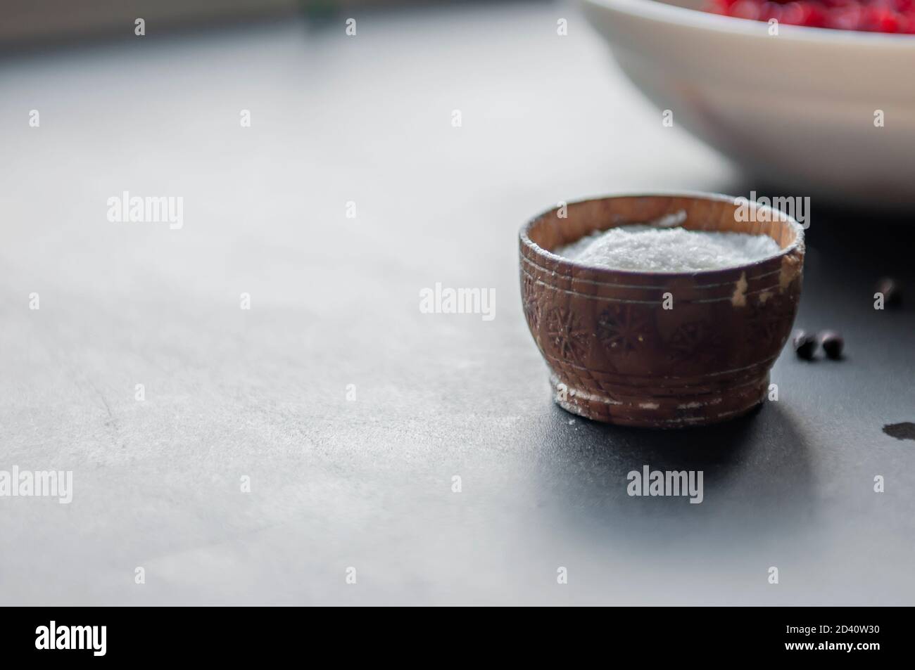Cooking spices sea salt in a wooden container black pea pepper on the