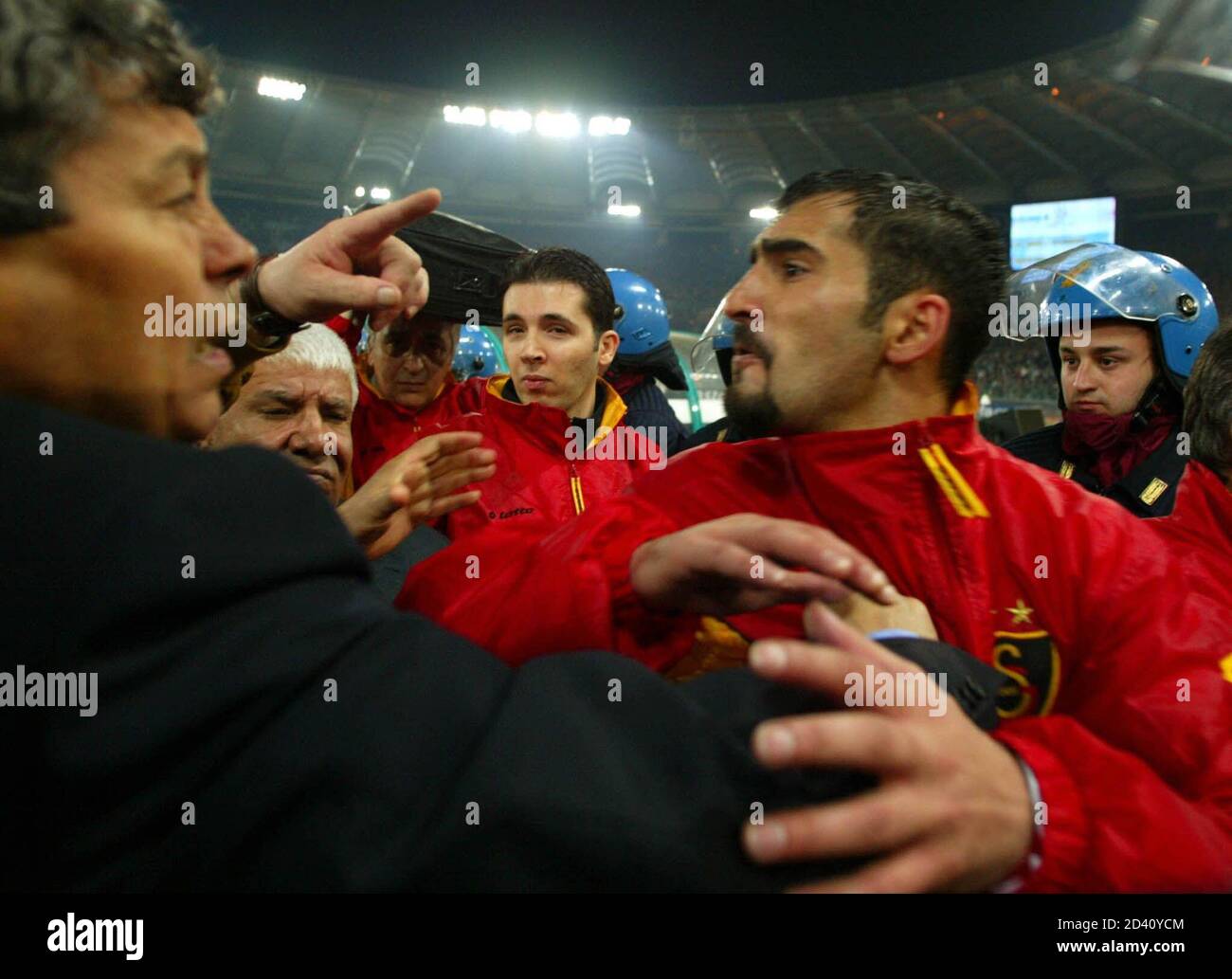 Galatasaray S Romanian Coach Mircea Lucescu L Stands With His Players During A Pitch Side Scuffle Following Their Champions League Group B Clash Against As Roma At The Olympic Stadium In Rome March 13