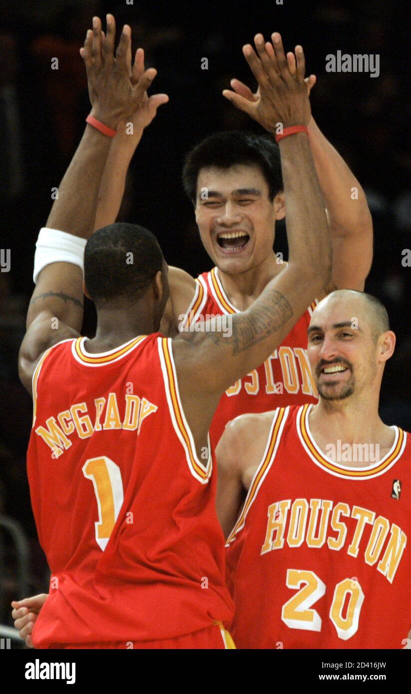 Houston Rockets center Yao Ming, guard Tracy McGrady (1) and guard Jon  Barry (20) celebrate after forward Scott Padgett made a last second shot to  beat the New York Knicks 92-91 in