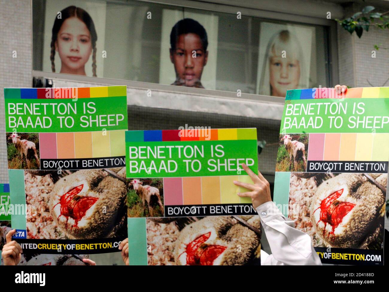 Members of People for the Ethical Treatment of Animals (PETA) hold banners  during a demonstration outside a Benetton clothing store in Sao Paulo July  18, 2005. PETA accused Benetton over its use