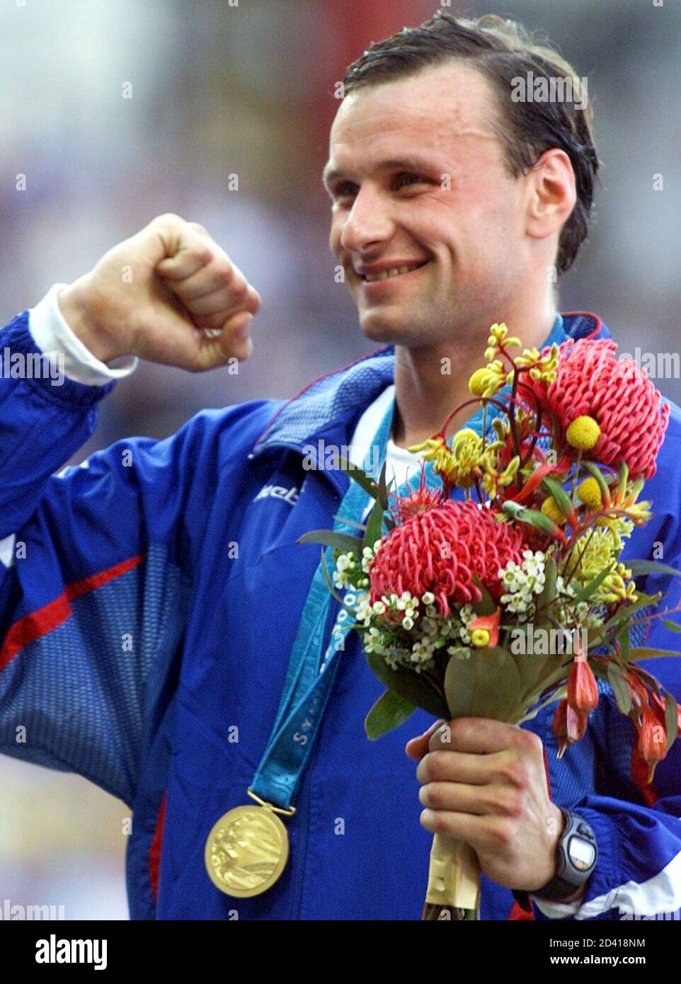 Dmitry Svatkovsky of Russia wears his gold medal for the men's modern pentathlon during the ceremony at the Sydney Olympics, September 30, 2000. [Gabor of Hungary won silver and Pavel