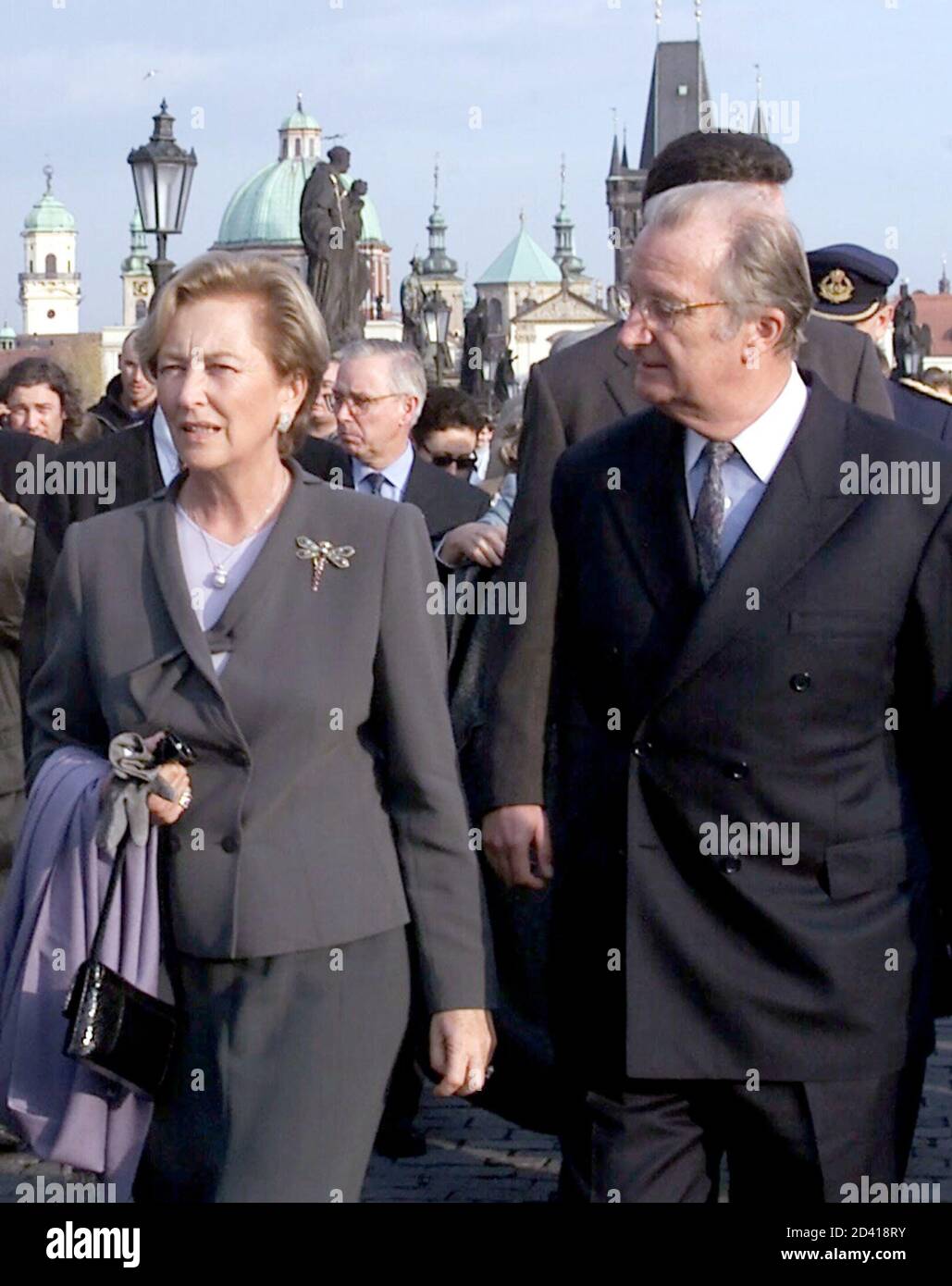 Belgian King Albert II and his wife the Queen Paola walk accross the