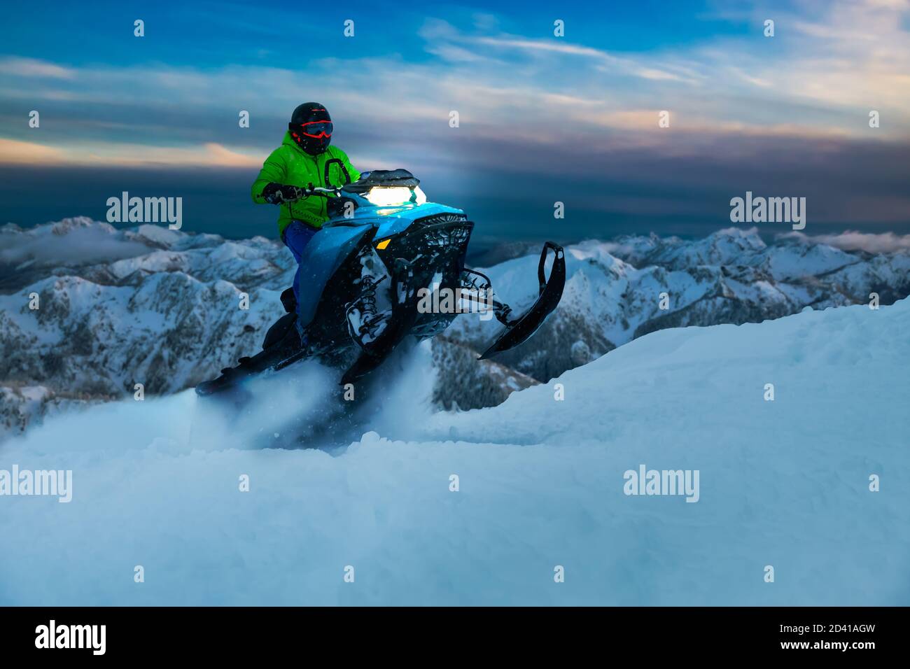 Adventurous Man Riding a Snowmobile in white snow Stock Photo - Alamy
