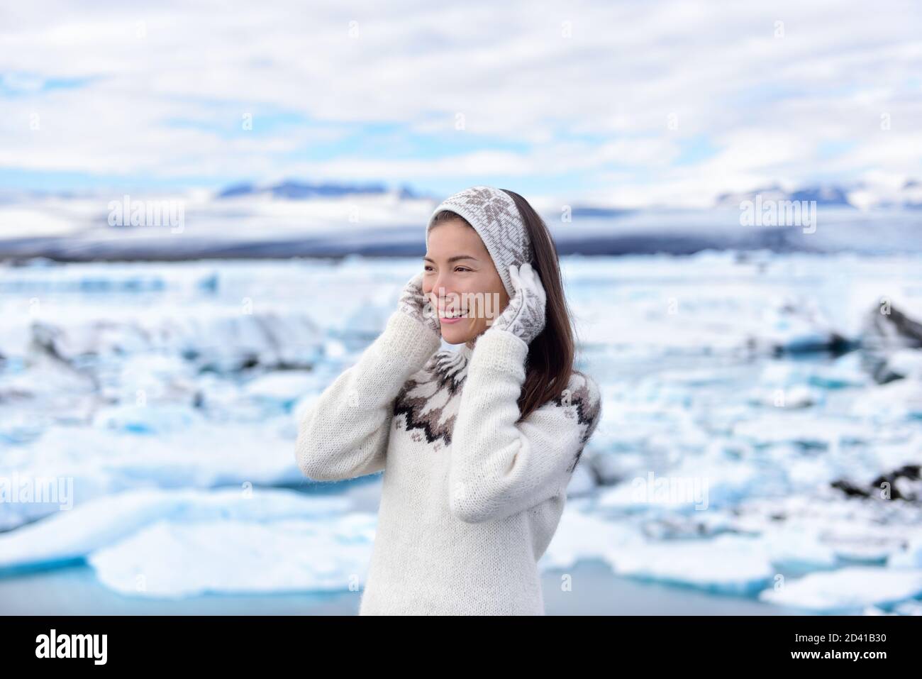 Portrait of multiracial woman on Iceland. Travel tourist in nature landscape by Jokulsarlon glacial lagoon on Iceland. Happy woman standing outdoors Stock Photo