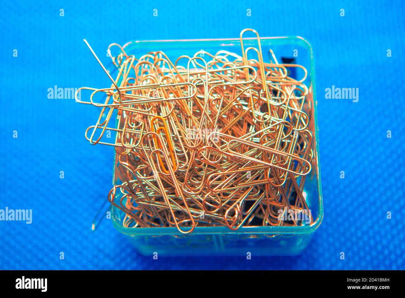 pile of paper clips on blue background Stock Photo Alamy