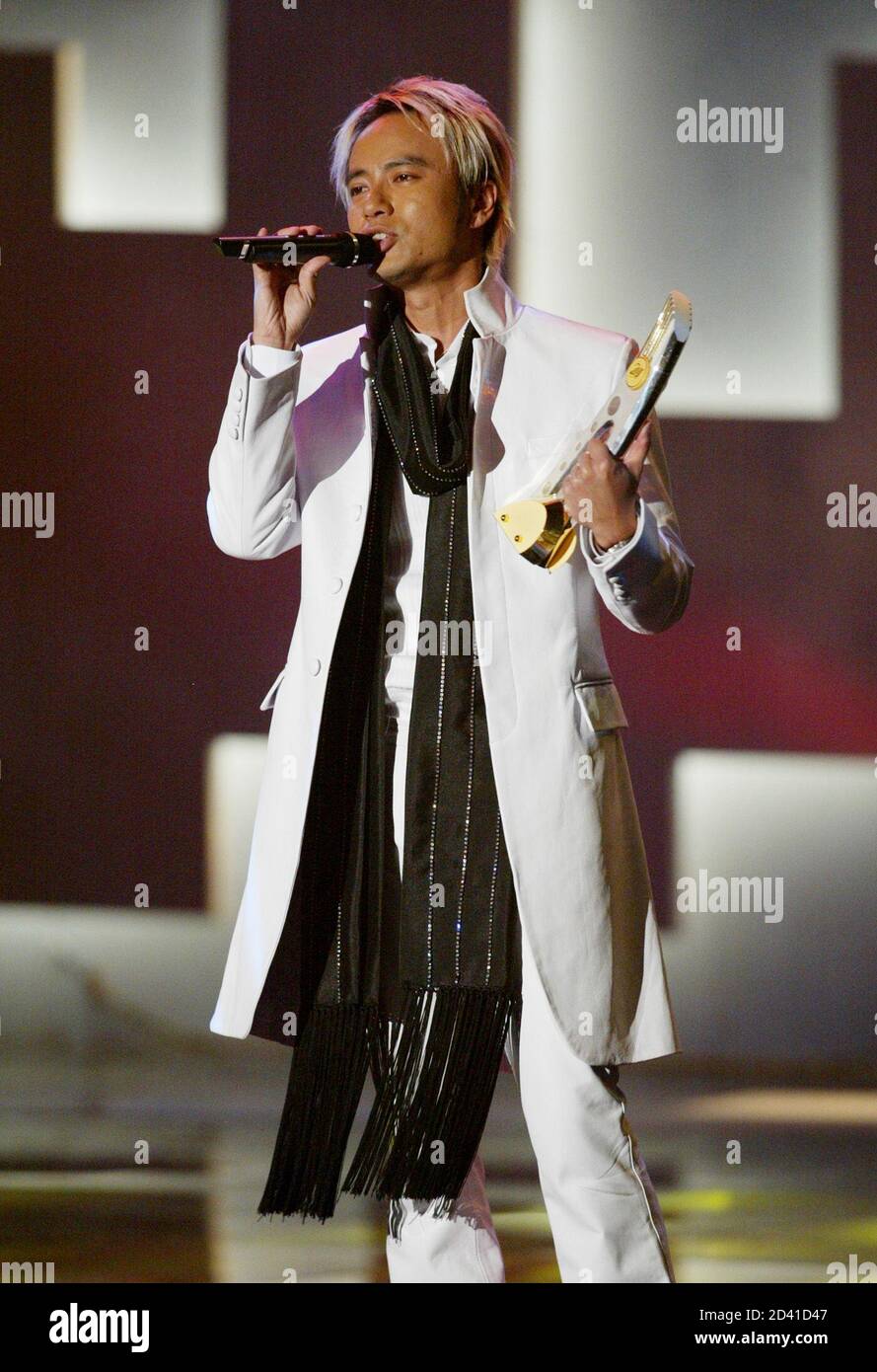 Hong Kong singer Hacken Lee performs after being awarded the best ten gold  song at the music presentation of the Jade Solid Gold Best 10 Awards for  year 2002 in Hong Kong