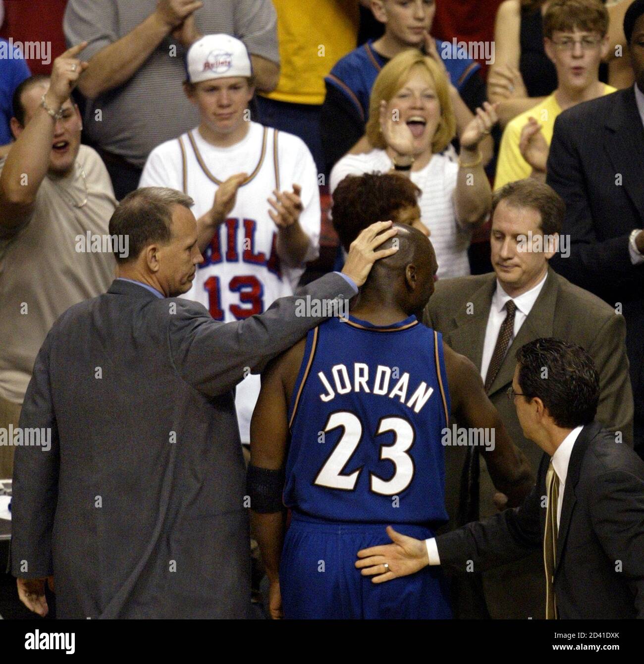Washington Wizards' Michael Jordan gets a pat on the head from coach Doug Collins as he comes out of the game after scoring the final point of his career on a foul shot with one minute and 45 seconds left in the game against the Philadelphia 76ers, in Philadelphia April 16, 2003. REUTERS/Ray Stubblebine  GMH/HB Stock Photo