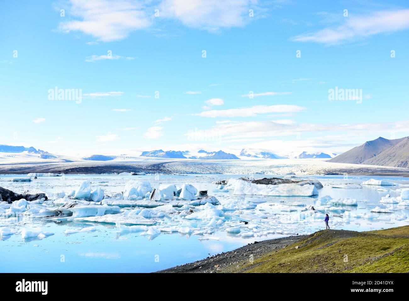 Iceland travel tourist enjoying view of nature landscape Jokulsarlon glacial lagoon / glacer lake on Iceland. Woman outdoors by tourist destination Stock Photo