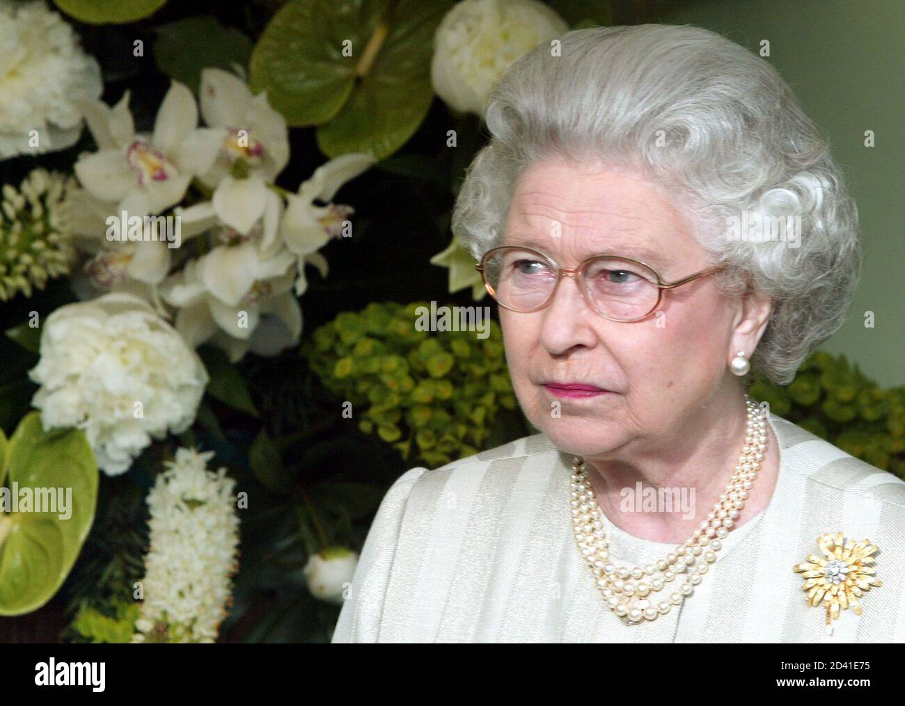 Britain's Queen Elizabeth II examines exhibits during her visit to the Royal Horticultural Society's Chelsea Flower Show in London May 19, 2003. Thousands of visitors are expected to attend the 81st annual show, organised by the Royal Horticultural Society and held at the Royal Hospital in Chelsea, west London. REUTERS/Stephen Hird SH/NMB Stock Photo