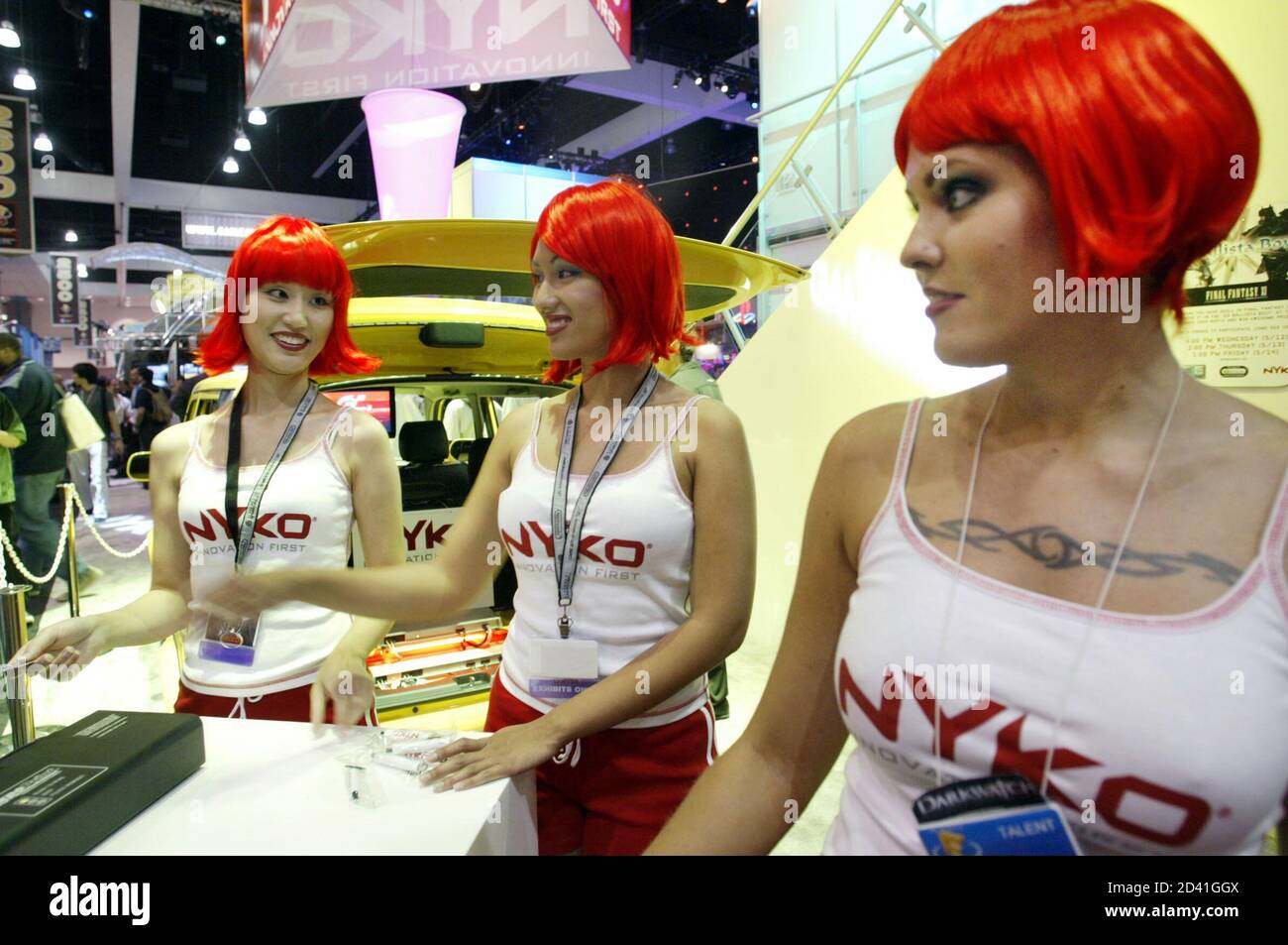 Red headed models Sindy Wei (L), Julie Anne Rose (C) and Letanya Tadlock  (R) work the display for Nyko Technologies at the Electronic Entertainment  Expo at the Convention Center in Los Angeles