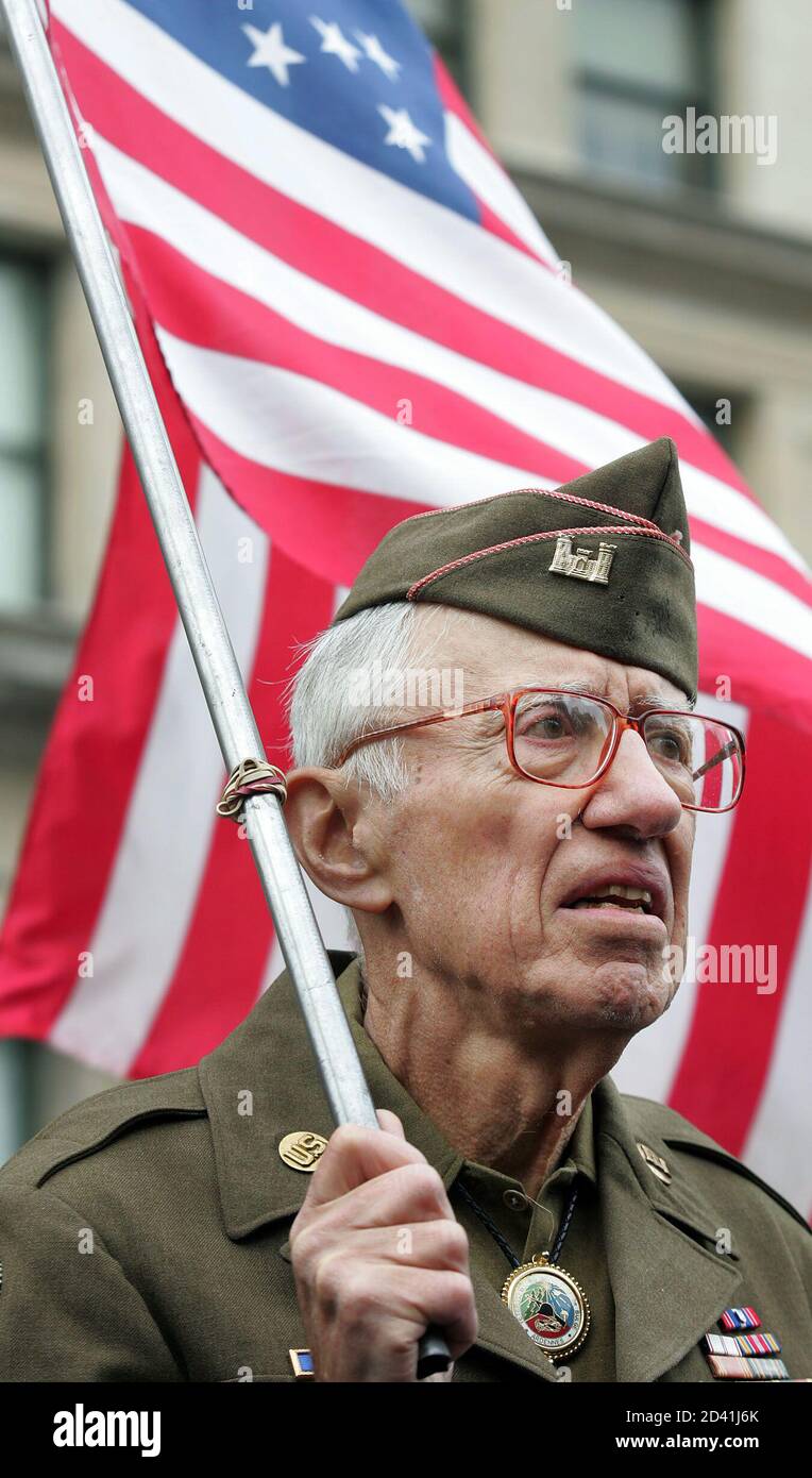 Army veteran of the World War II Battle of the Bulge, listens to ceremonies before the Veteran's Day Parade in New York.  Nicholas Zillas, an Army veteran of the World War II Battle of the Bulge, listens to ceremonies before the Veteran's Day Parade in New York, November 11, 2004. Thousands lined the Fifth Avenue parade route to salute vets. REUTERS/Jeff Zelevansky Stock Photo