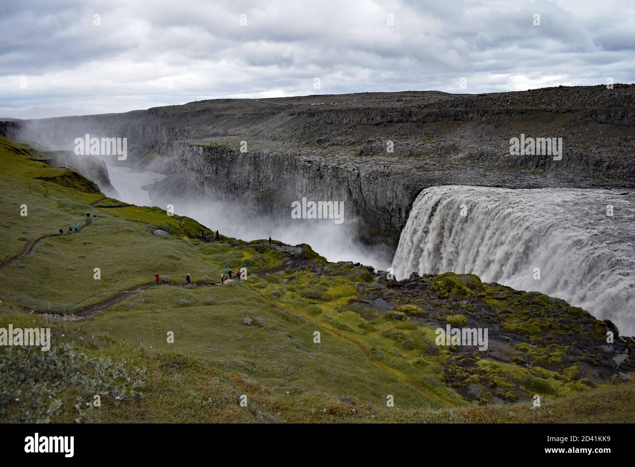 Dettifoss Waterfall in Northeast Iceland as it plunges into Jökulsárgljúfur canyon.  Mist rises from the power of the grey water rushing over the edge. Stock Photo