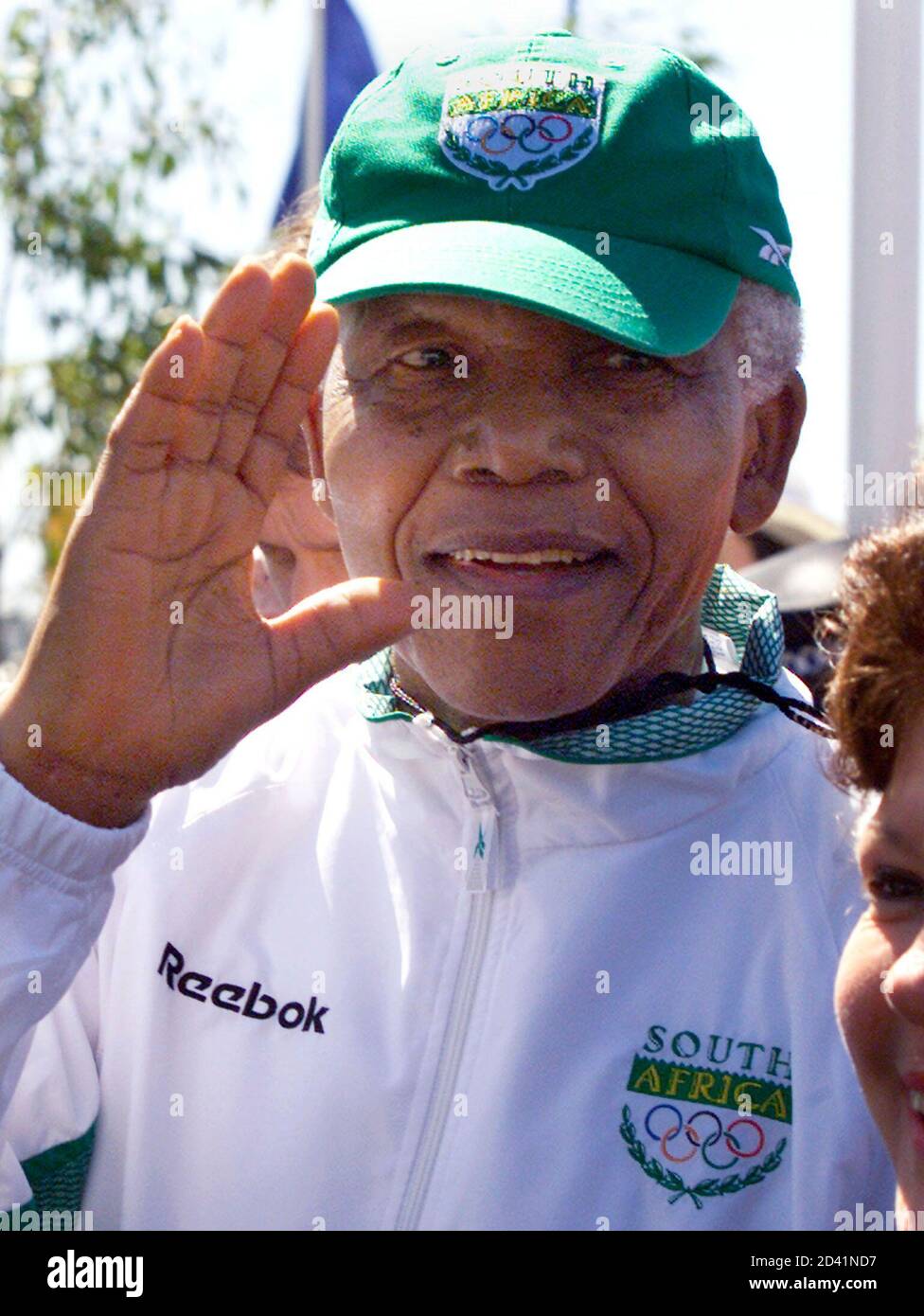 South Africa's Nelson Mandela, wearing a South African team outfit, waves  as he arrives at the athletes' village for the Sydney 2000 Olympic Games  September 5, 2000. Mandela toured the village and