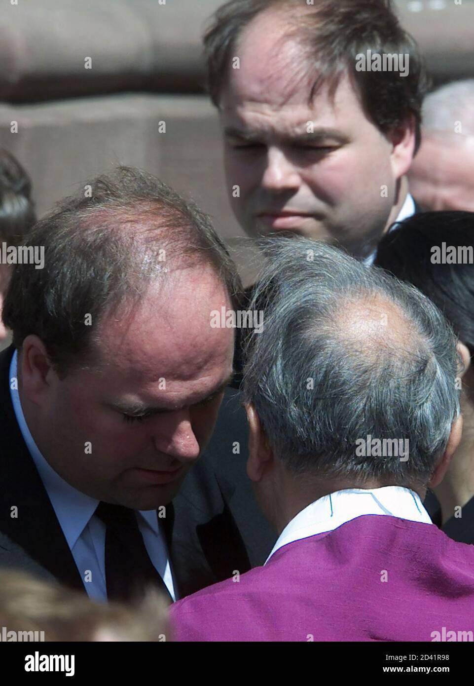 Son of Former German Chancellor Helmut Kohl, Walter (L) talks to Monsignore Erich Ramstetter as Kohl's other son Peter looks on after a memorial service for their mother Hannelore Kohl at the Speyer Cathedral July 11, 2001. Hannelore Kohl, who was 68, took her own life last week after a long illness. She had suffered from a rare allergy to light that forced her to stay in darkened rooms indoors for the last 15 months of her life.  JOH/GB Stock Photo