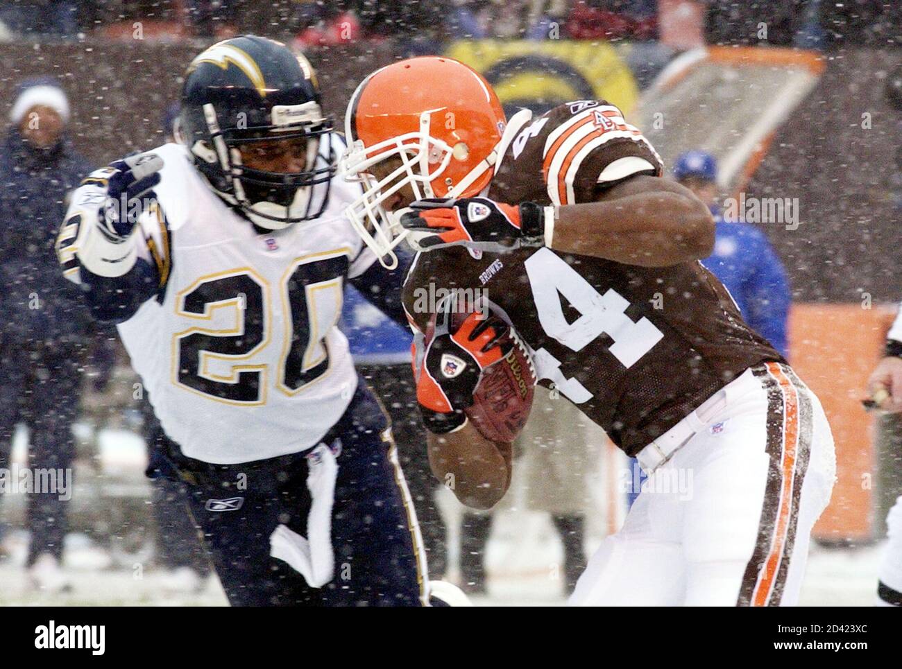 Cleveland Browns running back Lee Suggs (R) picks up a first down before  being stopped by Jerry Wilson of the San Diego Chargers, in the second  quarter of their NFL game in