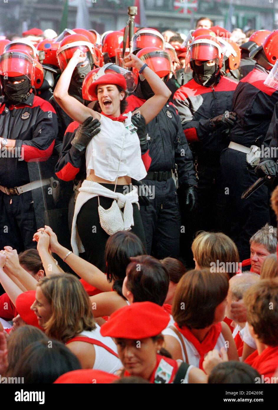 Basque policemen detain a group of women blocking a road during a march of traditionalists in the town of Hondarribia September 8, 2000. Police detained over 20 women. Traditionalist groups succeeded in preventing the participation of women in the all-male 'Alarde', a yearly parade celebrating an ancient war against French soldiers. Stock Photo