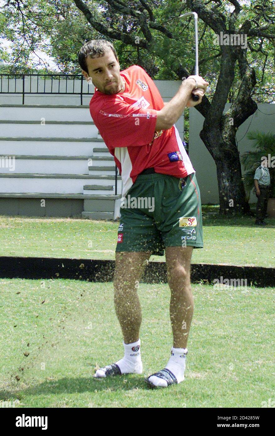 Mexico's midfielder Johan Rodriguez follows through after hitting a golf ball at the Campestre Club in Cali where the team is staying during the Copa America, July 13, 2001. Mexico upset Brazil in their first match of the tournament and plays Paraguay on July 15. RR Stock Photo