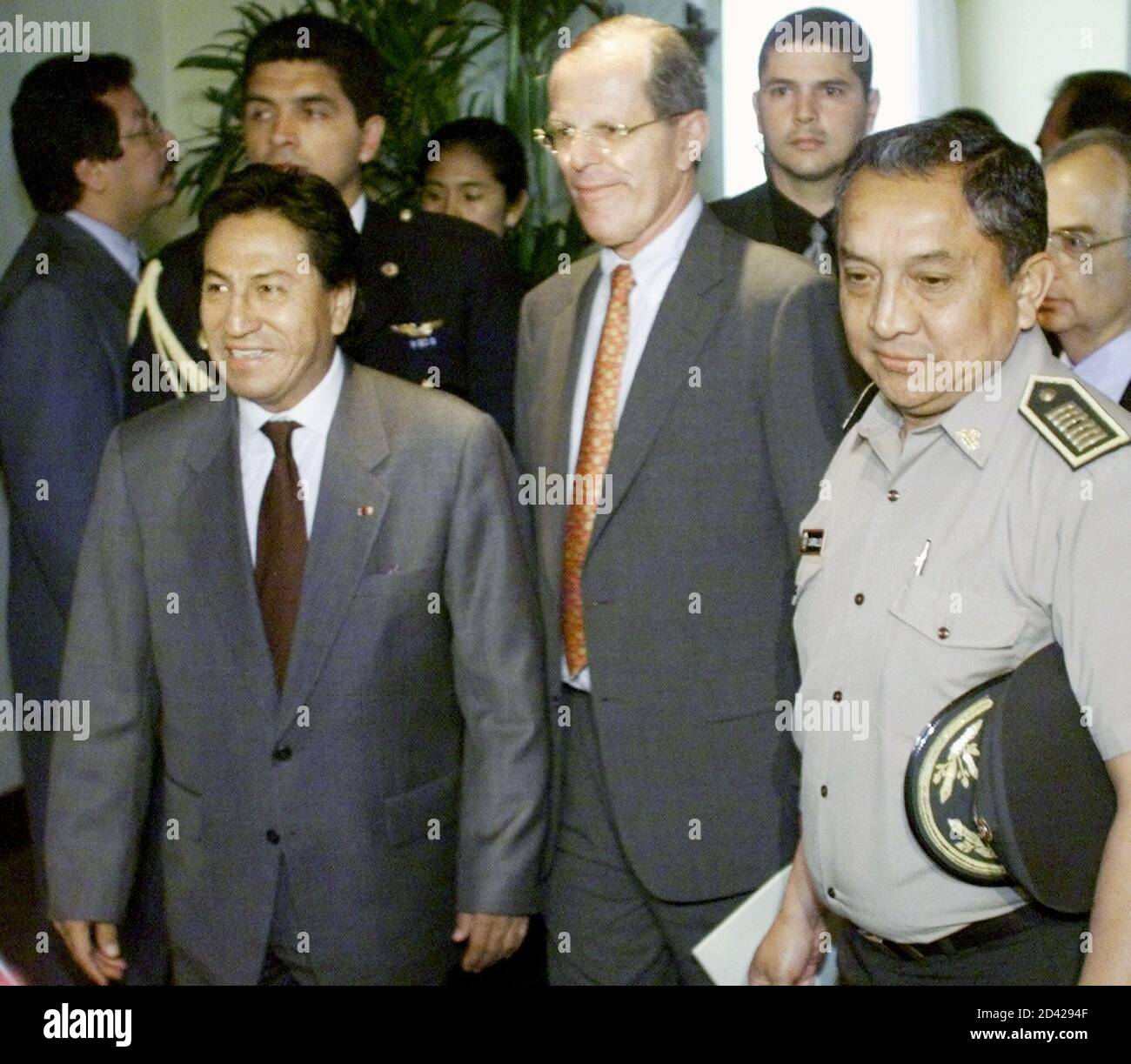 Peruvian President Alejandro Toledo (L) and his Economy Minister Pedro Pablo  Kuczynski (C) are escorted police after attending the IV Iberoamerican  economic ministers summit in Lima, November 21, 2001. Twenty-three heads of
