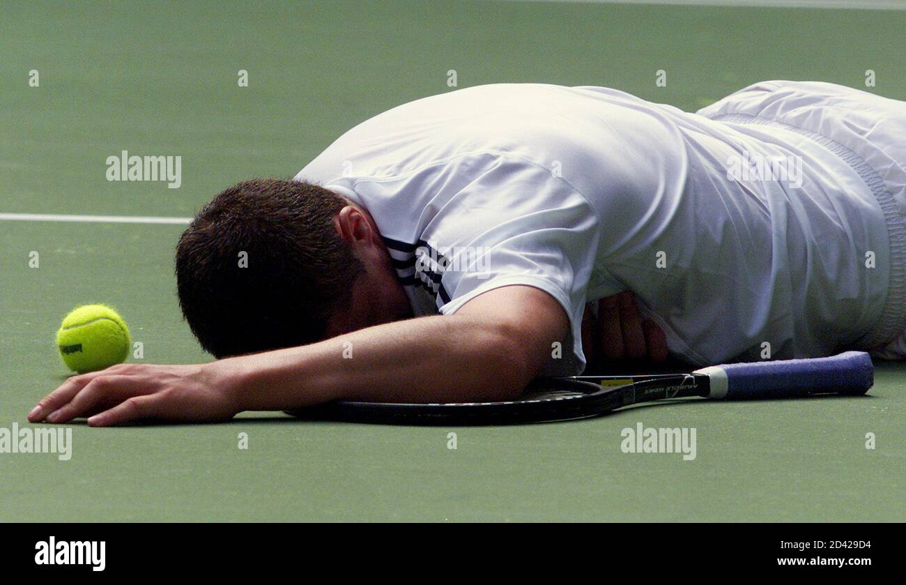 Russia's Marat Safin lies face down on the court during his first round  match against France's Anthony Dupuis at the Australian Open in Melbourne  January 15, 2002. Safin won in straight sets
