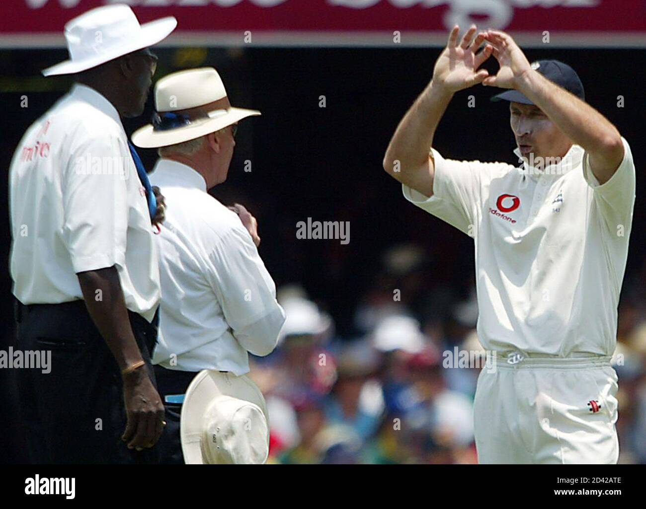 England's captain Nasser Hussain (R) argues with umpires Rudi Koetzen (C) and Steve Bucknor (L) after Australia's Mathew Hayden was caught by Simon Jones but fell out of the field of play during the first day's play in the first Ashes test match at the Gabba in Brisbane November 7, 2002. Australia have held the Ashes for the last six series. REUTERS/David Gray  DG/DL Stock Photo