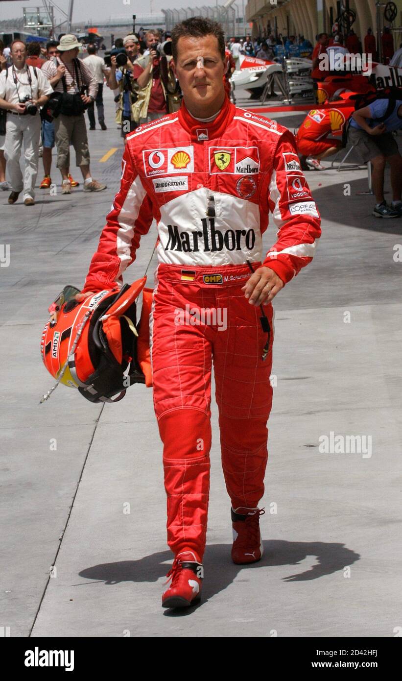 Ferrari Formula One World Champion Michael Schumacher of Germany walks in  the pits following the first practice session for the desert F1 Grand Prix  at the Bahrain International Circuit in Sakhir, south
