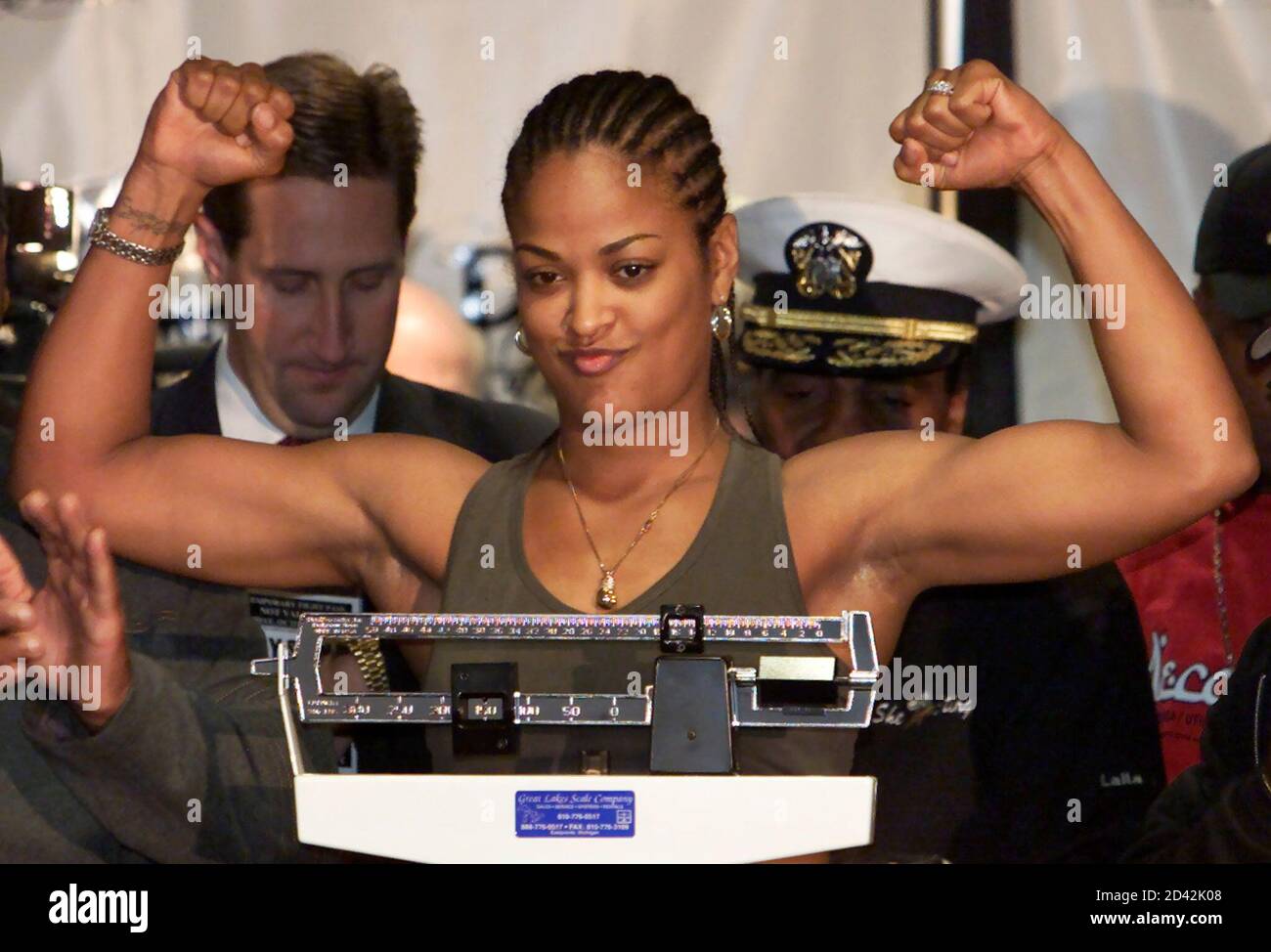 Laila Ali, daughter of boxing legend Muhammad Ali, flexes her muscles after  weighing in at 165