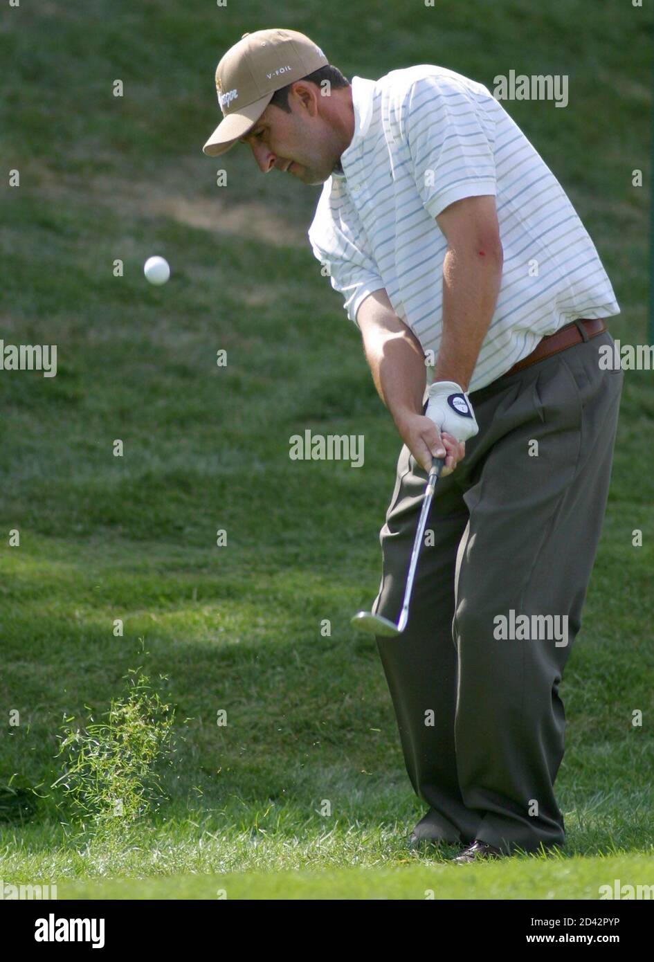 Jose Maria Olazabal of Spain chips from the rough near the ninth green during the second round of The International, in Castle Rock, Colorado, August 2, 2002. Olazabal is among the early leaders in the second round of the modified Stableford scoring tournament. REUTERS/Gary C. Caskey  GCC/HB Stock Photo