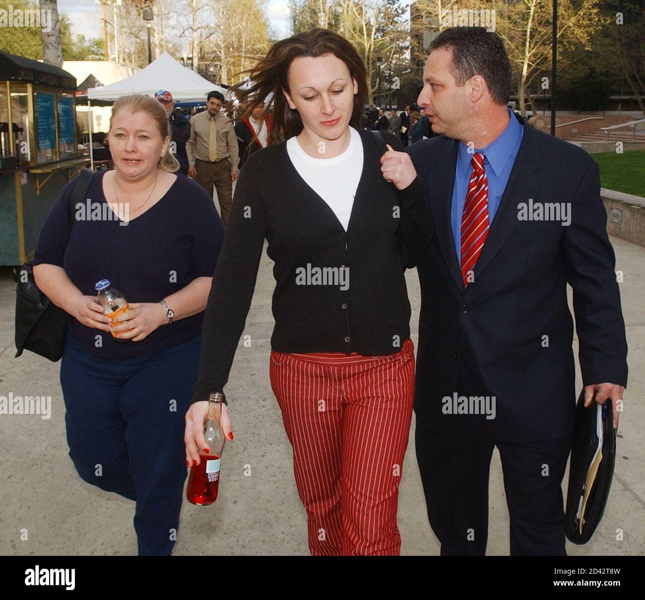 Marjorie Bakley (L) and Holly Bakley, sister and daughter respectively of Bonny  Lee Bakley depart the courthouse with their attorney in Van Nuys,  California February 26, 2003, after the first day of
