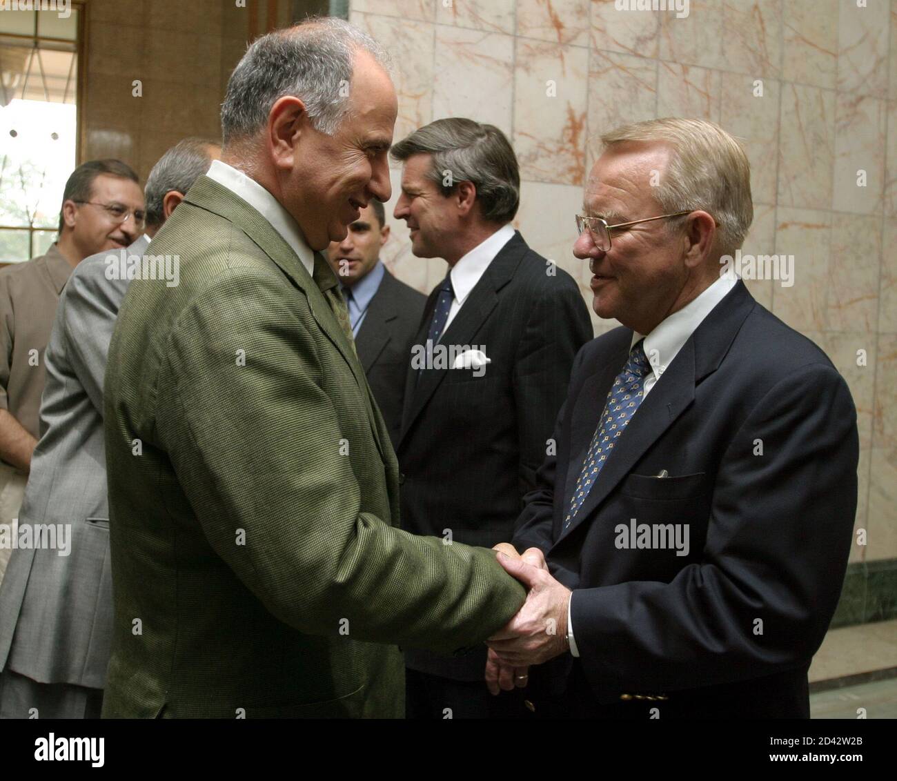 Retired U.S. General Jay Garner (R) greets the leader of the Iraqi National  Congress Ahmed Chalabi as new U.S. civil administrator to Iraq Paul Bremer  (2nd-R) is seen in background prior to