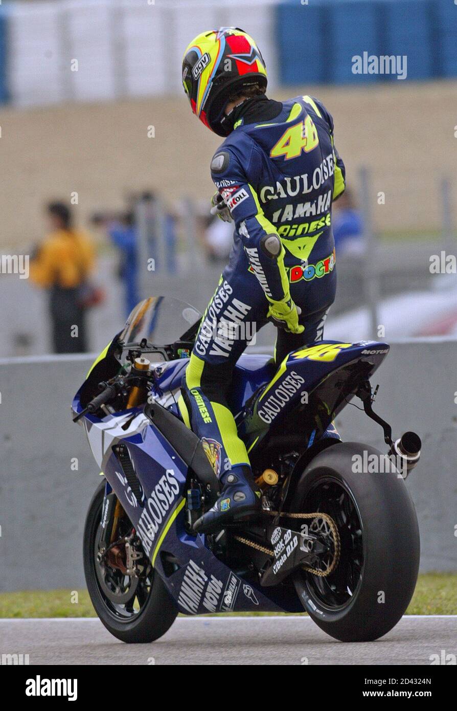 Italian rider Rossi adjusts his pants over his Yamaha motocycle during  practice session for Spain Grand Prix in Jerez. Italian rider Valentino  Rossi adjusts his pants over his Yamaha motorcycle during the