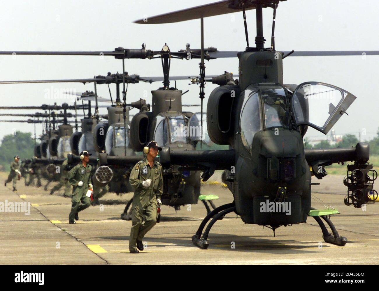 A Taiwan army ground crew run towards U.S.-made AH1W attack helicopters prior to a demonstration of their unit's flying skills at a military base in Taichung August 21, 2001, after being selected as model troops. In an annual contest the military chooses model troops from each branch of the military services.  SK/AH/PB Stock Photo