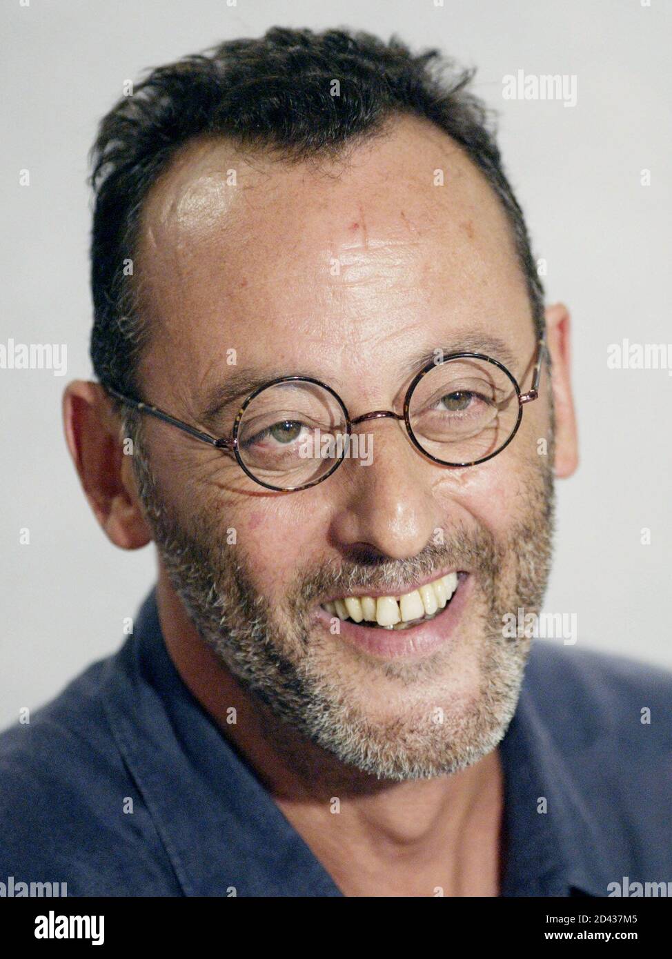 French actor Jean Reno smiles during a press conference to promote his film  "Jet Lag" at the 27th Toronto International Film Festival in Toronto,  September 9, 2002. [The film is a high-flying