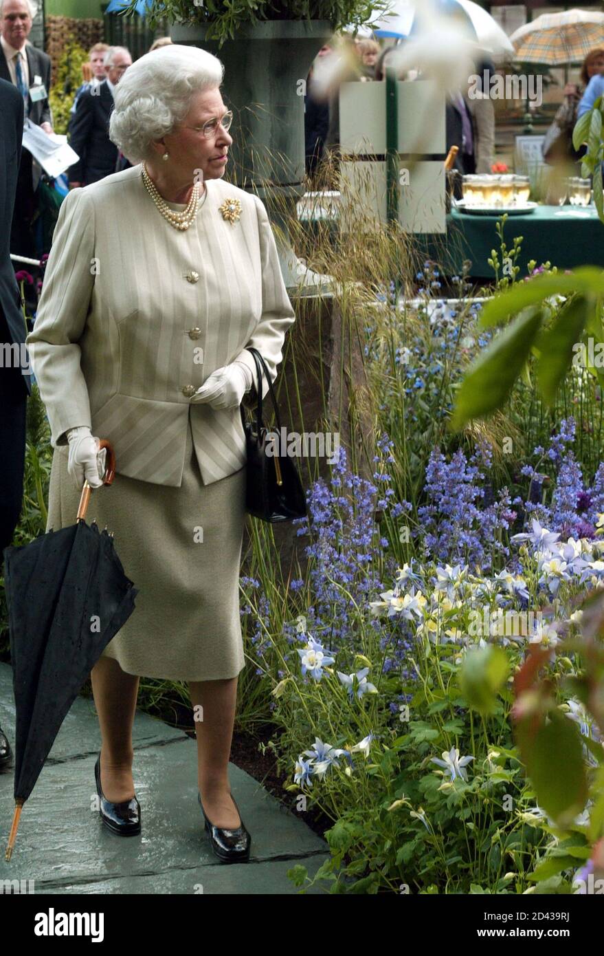 Britain's Queen Elizabeth II examines exhibits during her visit to the Royal Horticultural Society's Chelsea Flower Show in London May 19, 2003. Thousands of visitors are expected to attend the 81st annual show, organised by the Royal Horticultural Society and held at the Royal Hospital in Chelsea, west London. REUTERS/Stephen Hird  SH/NMB Stock Photo