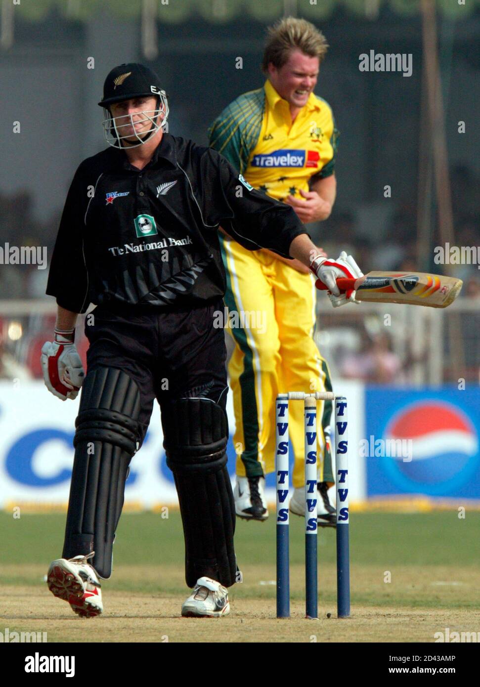 Australian bowler Brad Williams (R) jumps in jubliation after taking the wicket of New Zealand batsman Scott Styris in the third one-dayer of the triangular series in Faridabad, October 29, 2003. REUTERS/Kamal Kishore  KK/RCS Stock Photo