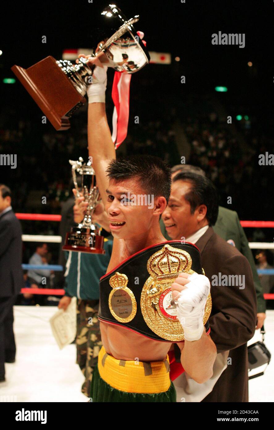 WBA FEATHERWEIGHT CHAMPION INDONESIA'S CELEBRATES AFTER WINNING THE TITLE BOUT AGAINST JAPANESE CHALLENGER SATO IN TOKYO. World Boxing Association (WBA) featherweight champion Indonesia's Chris John celebrates as he raises his winning