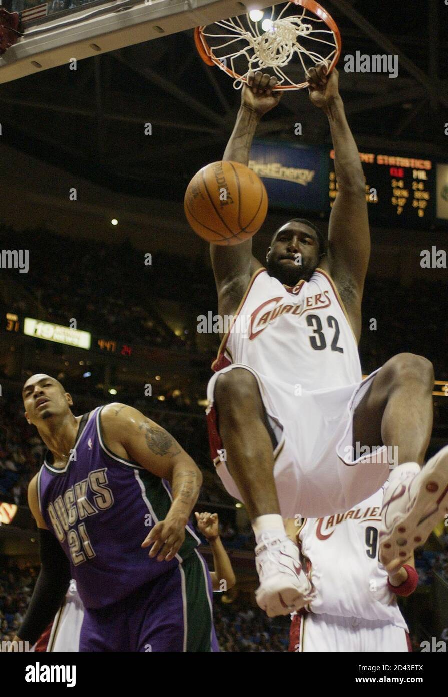 Robert Traylor of the Cleveland Cavaliers dunks ball as Marcus Fizer of the  Milwaukee Bucks looks on in the second quarter of game at Gund Arena in  Cleveland, Ohio, April 9, 2005.