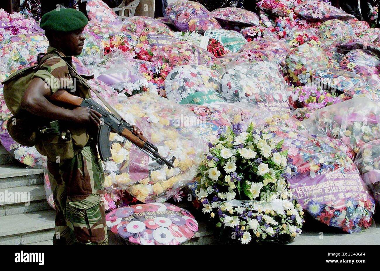 A Heavily Armed Soldier Guards A Pile Of Flowers Left At The People S Palace In Kinshasa January 23 2001 Democratic Republic Of Congo On Tuesday Promised A Full Inquiry Into The Killing