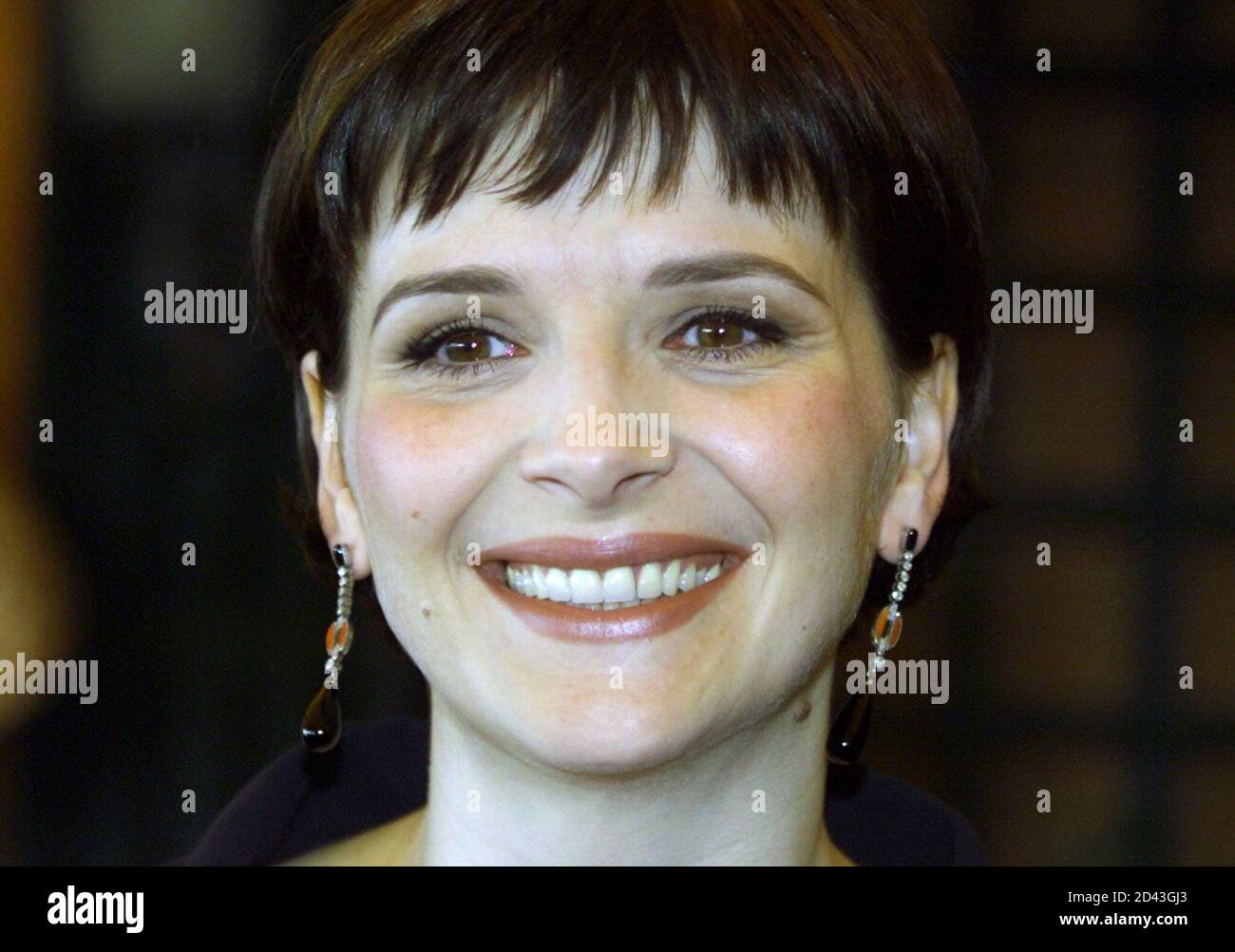 French actress Juliette Binoche smiles as she arrives for a press