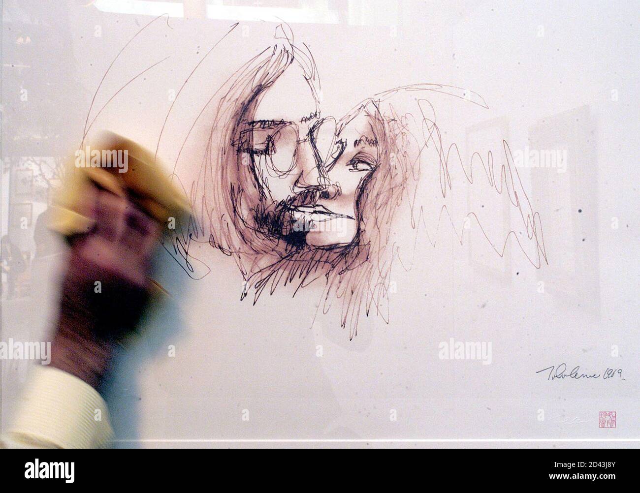 A Gallery Technician Polishes The Glass Of A Self Portrait By Former Beatle John Lennon At The Launch Of The John Lennon Exhibition In Chelsea West London September 6 01 The Exhibition Features