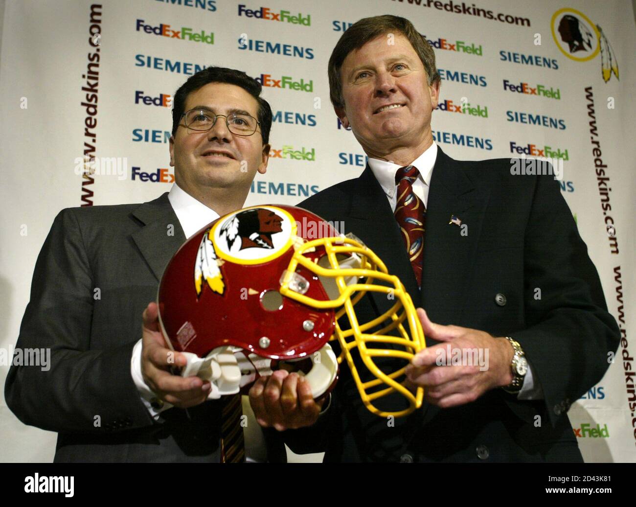 New Washington Redskins head coach Steve Spurrier (R) holds a Redskins helmet with team owner Dan Snyder during a press conference at Redskin Park in Ashburn, Virginia January 15, 2002. Spurrier was New Washington Redskins head coach Steve Spurrier (R) holds a Redskins helmet with team owner Dan Snyder during a press conference at Redskin Park in Ashburn, Virginia January 15, 2002. Spurrier was