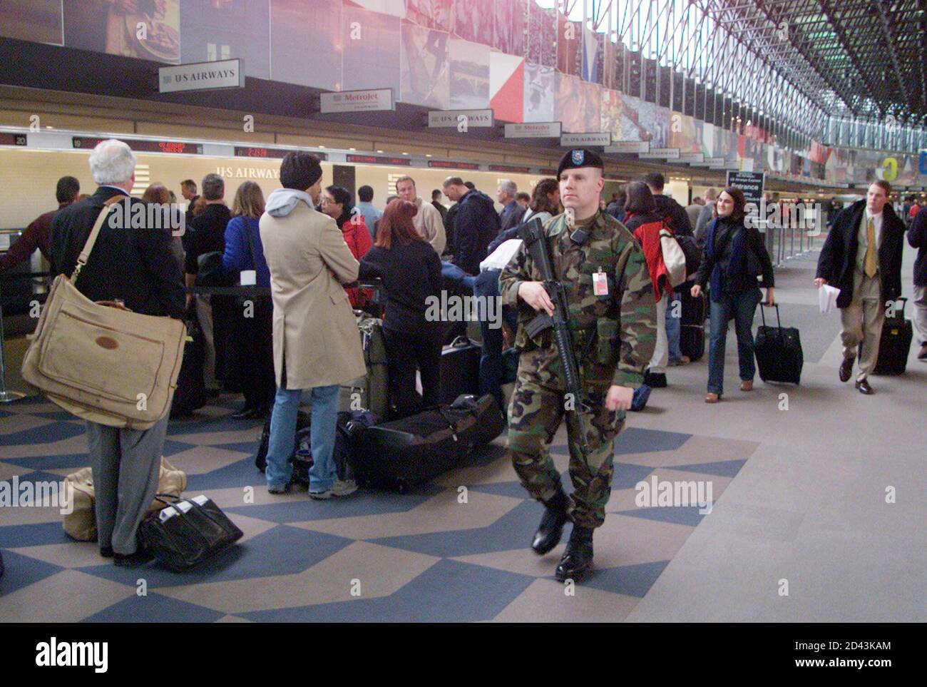 A member of the National Guard patrols the Southwest Airlines ticket counter area at BWI Airport after a potential security breech occured at the Southwest baggage screening area at Terminal B February 7, 2002. The Federal Aviation Administration (FAA) ordered the concourse evacuated and examined by security officials with dogs before it was reopened an hour later. Over 1,500 passengers had to leave the area and then wait in line to get re-screened for their flights. REUTERS/Joe Giza  JG/GN Stock Photo