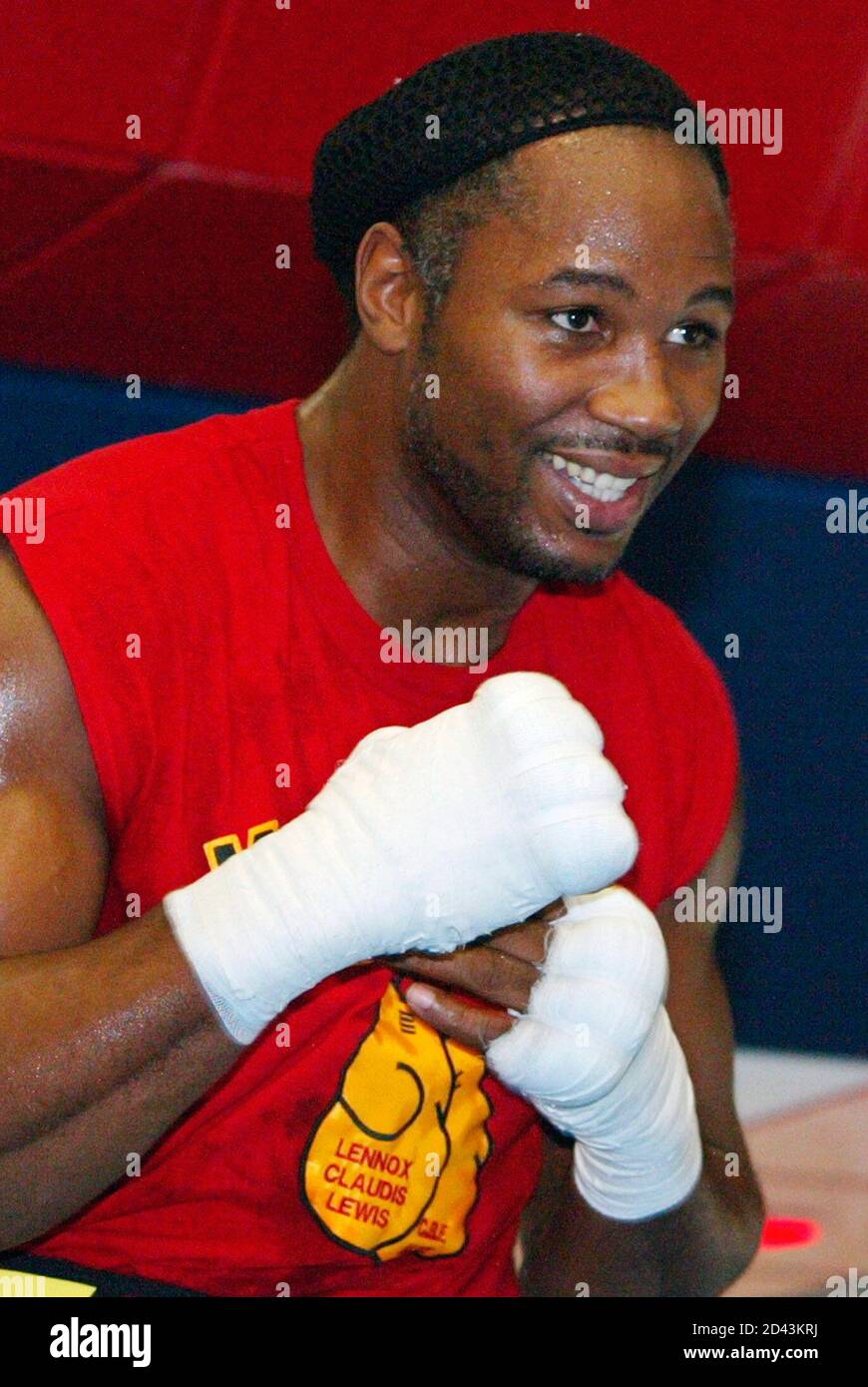Boxer Lennox Lewis grins as he shadow boxes during a light workout after he  held a press conference at his Scotrun, Pennsylvania, training facility May  7, 2002. Lewis will face Mike Tyson