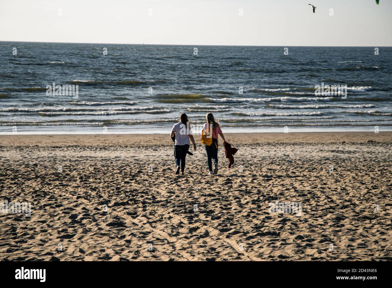 Women walking on sandy beach Stock Photo - Alamy