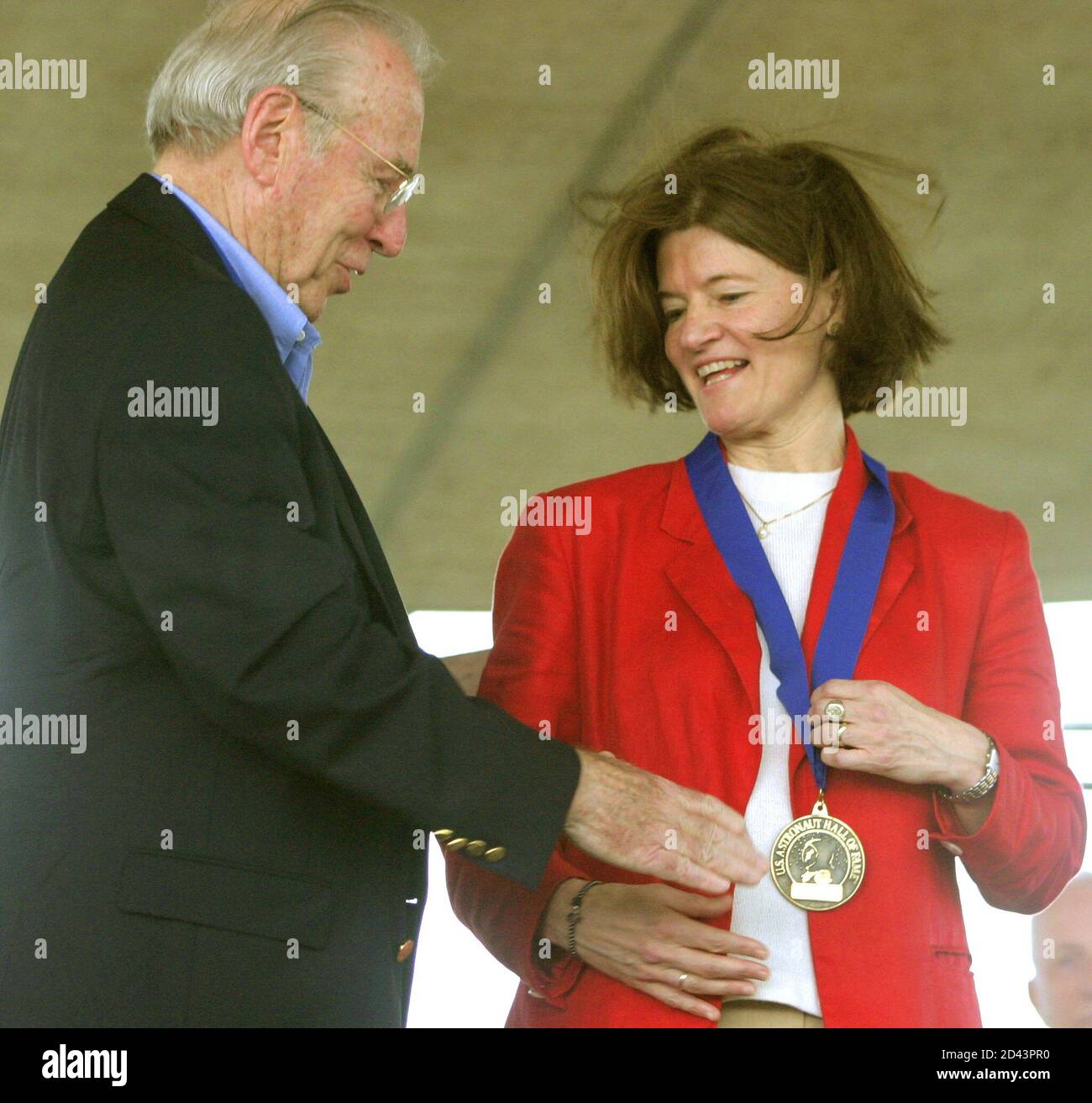 Former shuttle astronaut Sally Ride (R) is congratulated by former Apollo 13 Commander James Lovell (L) after being inducted into the Astronaut Hall of Fame in Titusville, Florida on June 21, 2003. Ride was one of four astronauts honored at the Kennedy Space Center Visitor Complex, and was the first American woman to fly in space. REUTERS/Charles W. Luzier  CWL/GAC Stock Photo