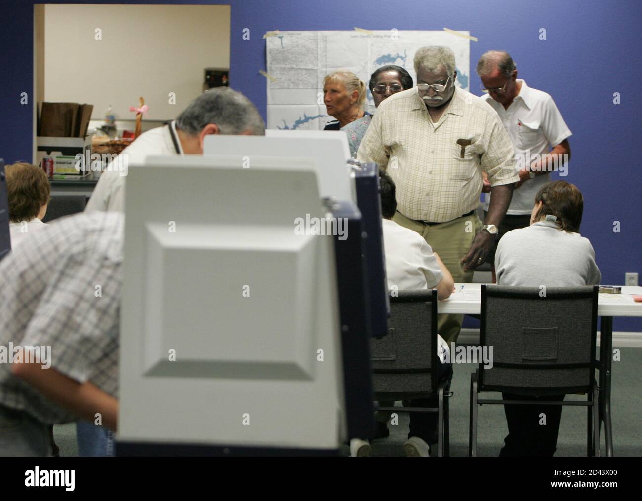 Louis Henry (R) waits to sign for his ballot at precinct 4457 in Leon County, Florida during the early voting hours on November 2, 2004. Voters turned out in large numbers on Tuesday to deliver an unpredictable verdict on U.S. President George W. Bush and Democratic nominee John Kerry as the long, bitter and deadlocked White House race drew to a close. REUTERS/Mark Wallheiser US ELECTION  MW Stock Photo