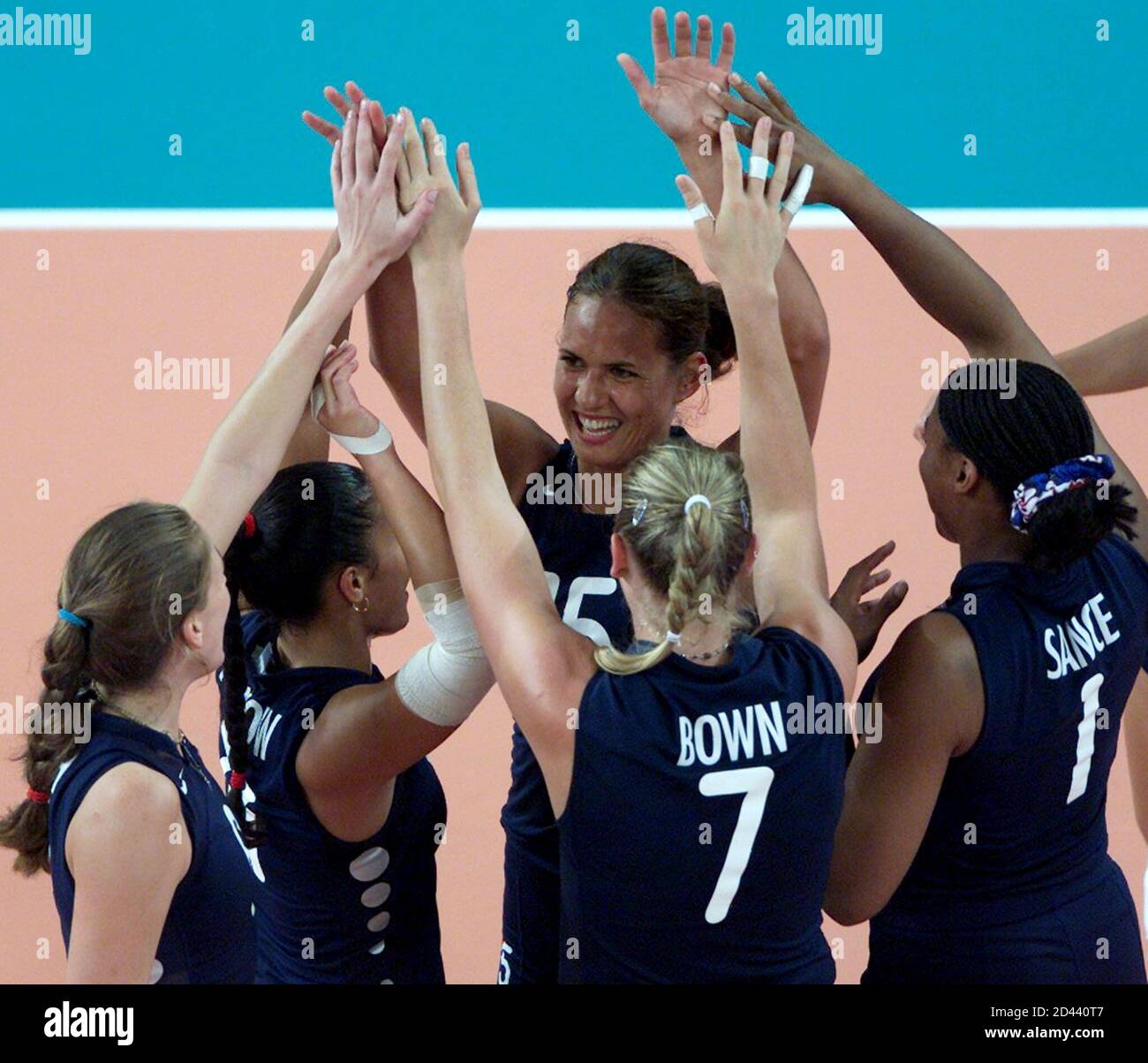Members of the USA women's volleyball team celebrate their win against