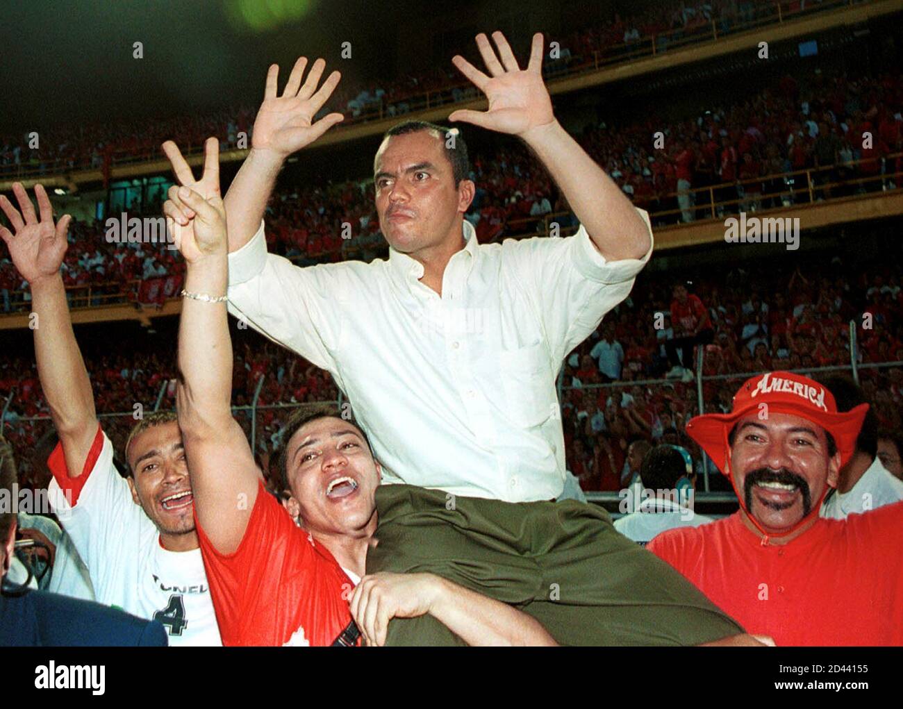 America's coach Jaime de la Pava is carried on the shoulders of fans after  beating Deportes Tolima during the final match of the Colombian soccer  league, December 17, 2000. America defeated Tolima